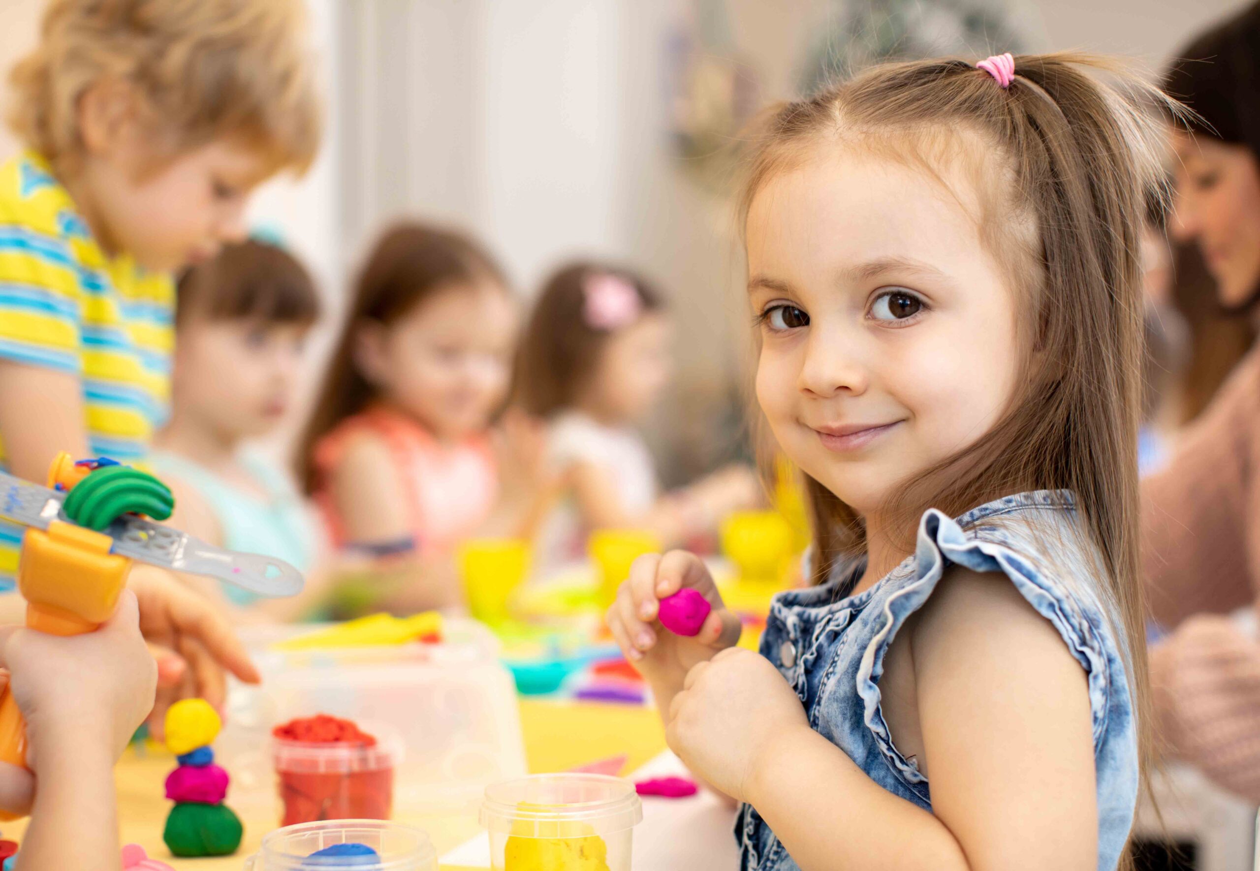 happy kids doing arts and crafts in day care centre